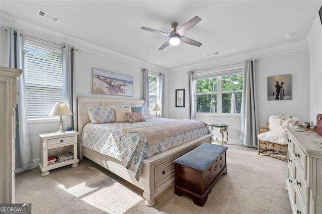 carpeted bedroom featuring ceiling fan, ornamental molding, and multiple windows