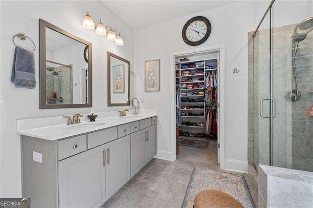 bathroom with tile patterned flooring, vanity, and a shower with shower door