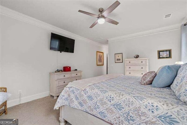 carpeted bedroom with ceiling fan and ornamental molding