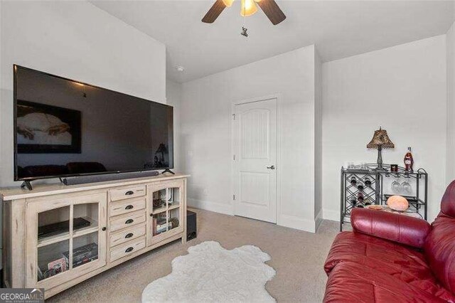 living room with ceiling fan and light colored carpet