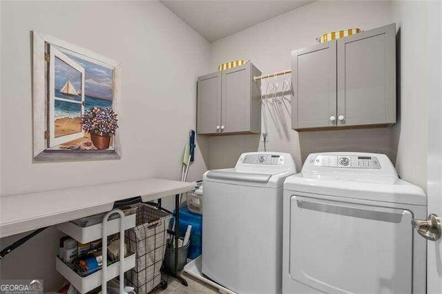 washroom featuring cabinets and washer and dryer