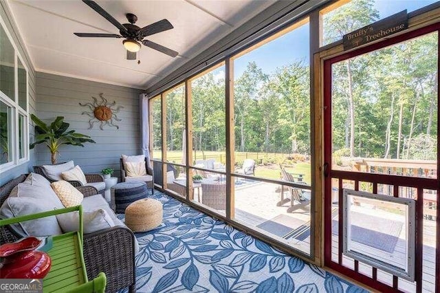 sunroom featuring ceiling fan