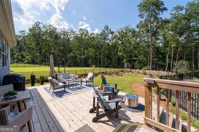 wooden deck with a lawn and an outdoor living space