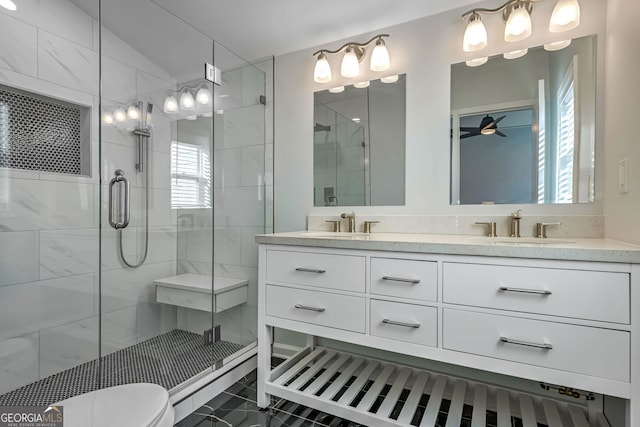 bathroom featuring ceiling fan, vanity, a healthy amount of sunlight, and an enclosed shower