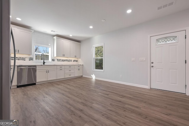 kitchen featuring white cabinets, stainless steel appliances, and a wealth of natural light