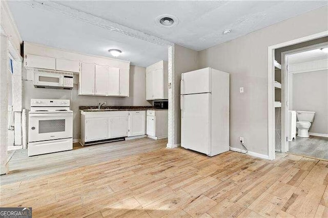 kitchen featuring sink, white cabinets, light hardwood / wood-style floors, and white appliances