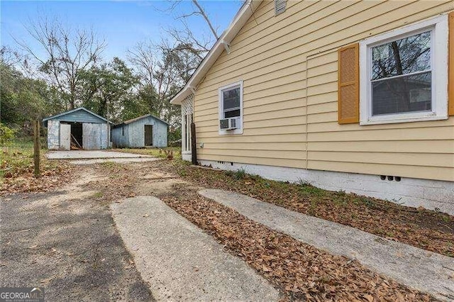 view of home's exterior with a storage shed