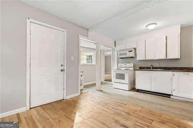 kitchen with light hardwood / wood-style floors, white cabinetry, white appliances, and sink