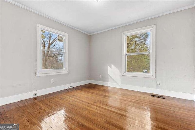 spare room with hardwood / wood-style flooring and ornamental molding