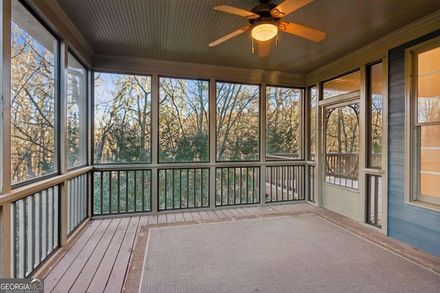 unfurnished sunroom with ceiling fan and plenty of natural light