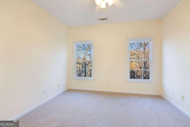 unfurnished room with ceiling fan and light colored carpet