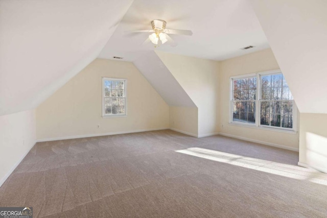 bonus room featuring ceiling fan, light colored carpet, and vaulted ceiling