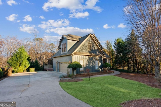 view of side of property featuring a yard and a garage