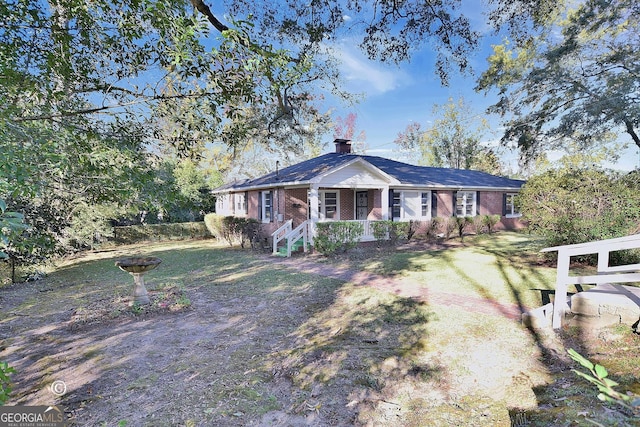 ranch-style home featuring a front yard and a porch