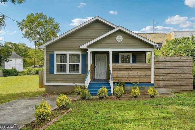 bungalow-style home featuring a front lawn