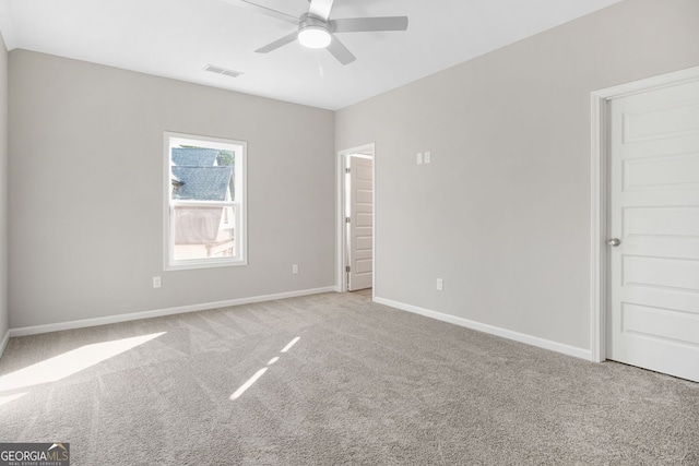 carpeted spare room featuring ceiling fan