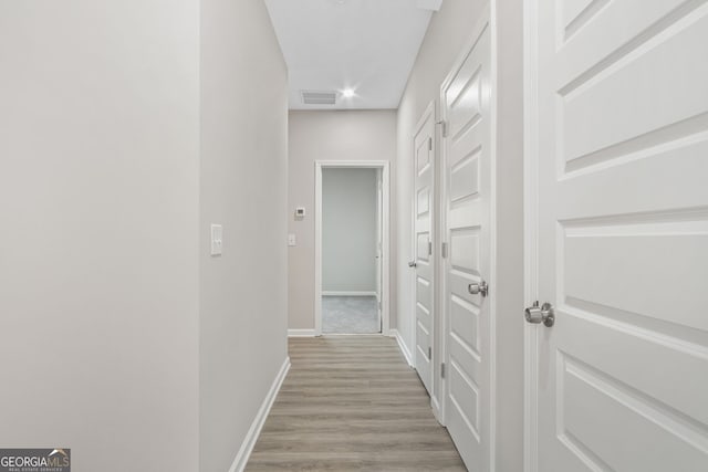 corridor featuring light hardwood / wood-style floors