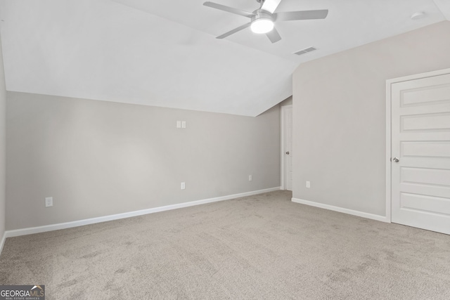 additional living space featuring ceiling fan, carpet, and lofted ceiling