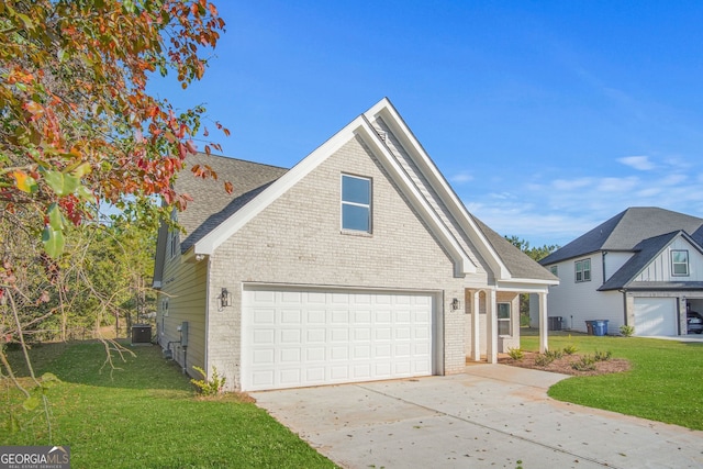 front of property with central AC, a front yard, and a garage