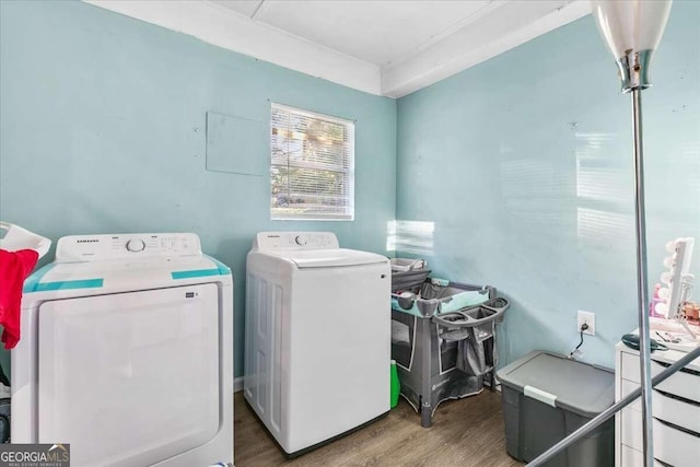 laundry area featuring washer and dryer and wood-type flooring