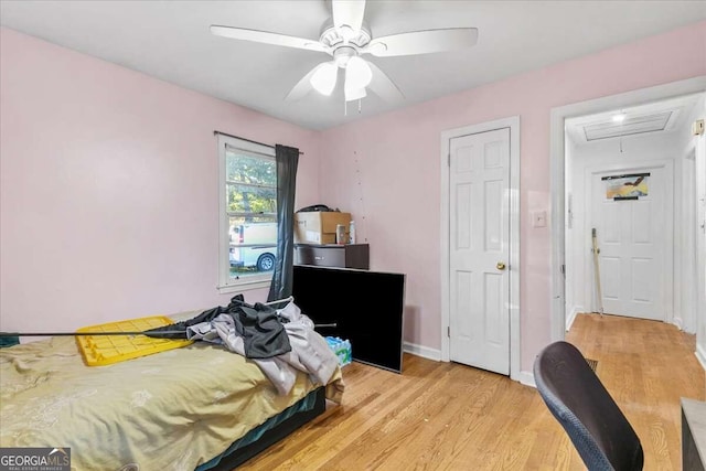 bedroom with ceiling fan and light hardwood / wood-style floors