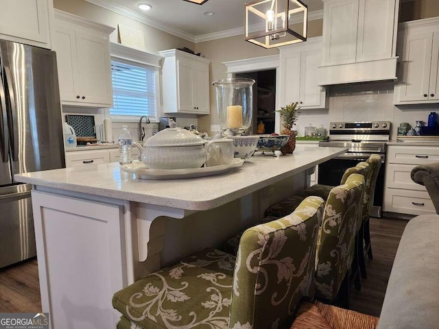 kitchen with custom range hood, stainless steel appliances, pendant lighting, white cabinets, and a kitchen island