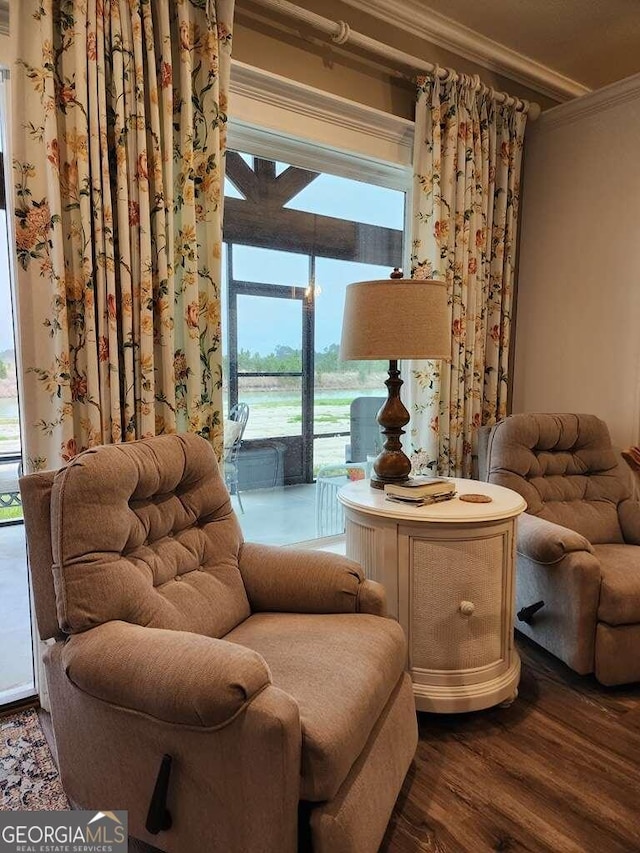 sitting room featuring hardwood / wood-style floors and ornamental molding