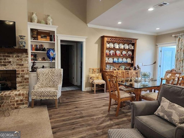 interior space with a fireplace, dark hardwood / wood-style flooring, and ornamental molding