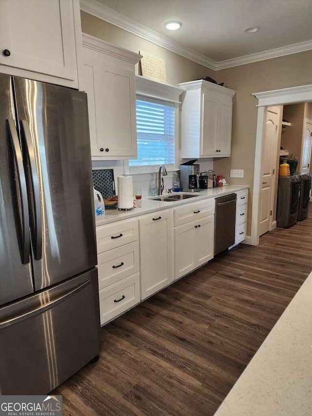 kitchen featuring white cabinets, appliances with stainless steel finishes, and sink