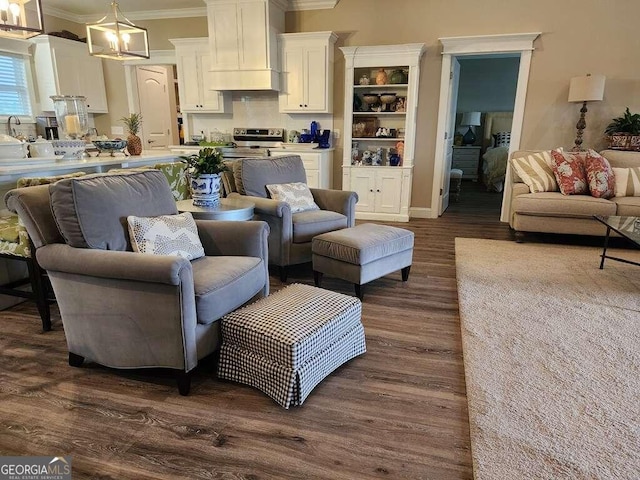 living room featuring dark hardwood / wood-style flooring and crown molding