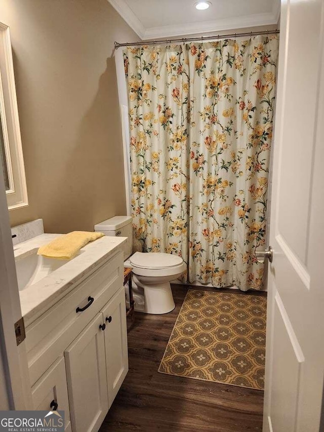 bathroom featuring hardwood / wood-style floors, vanity, toilet, and ornamental molding