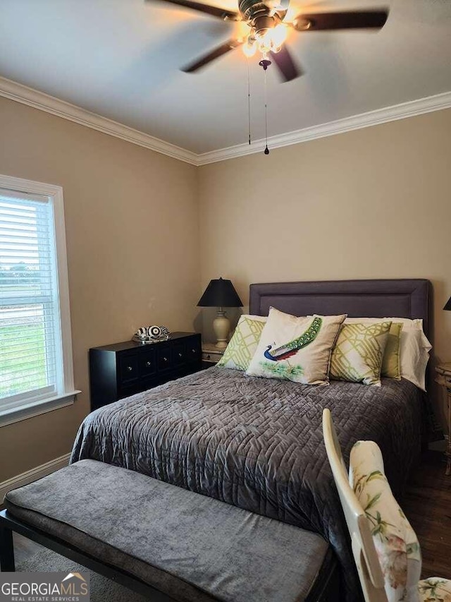 bedroom with ceiling fan, crown molding, and dark wood-type flooring