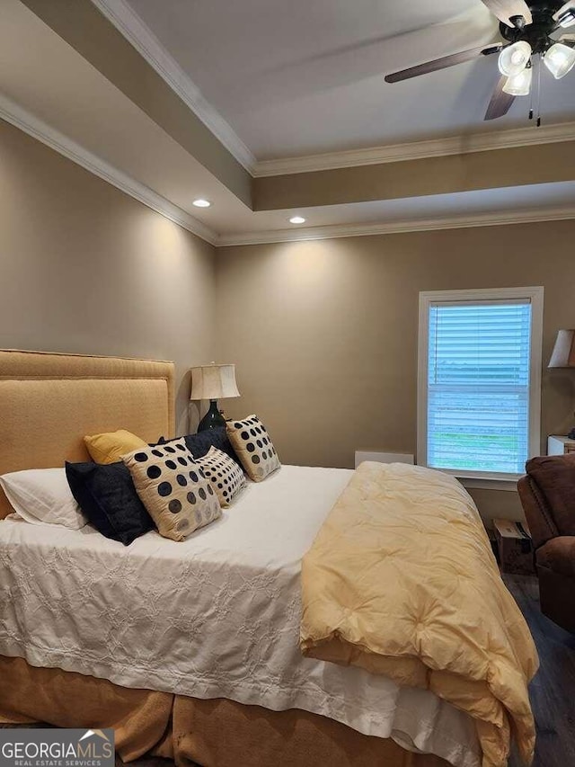 bedroom featuring ceiling fan, crown molding, and hardwood / wood-style floors