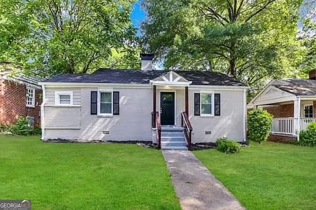 bungalow-style home with a front lawn