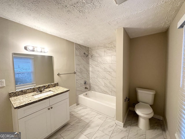 full bathroom with vanity, toilet, a textured ceiling, and tiled shower / bath