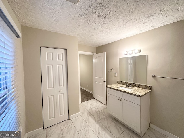 bathroom with vanity and a textured ceiling