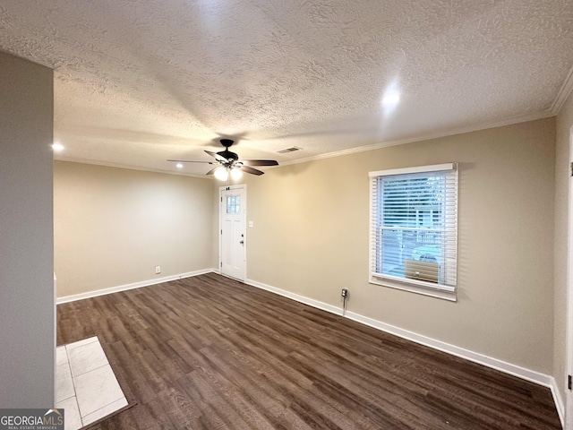 empty room featuring ceiling fan, dark hardwood / wood-style flooring, a textured ceiling, and ornamental molding