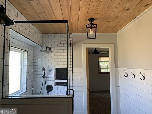 bathroom featuring wooden ceiling and ornamental molding