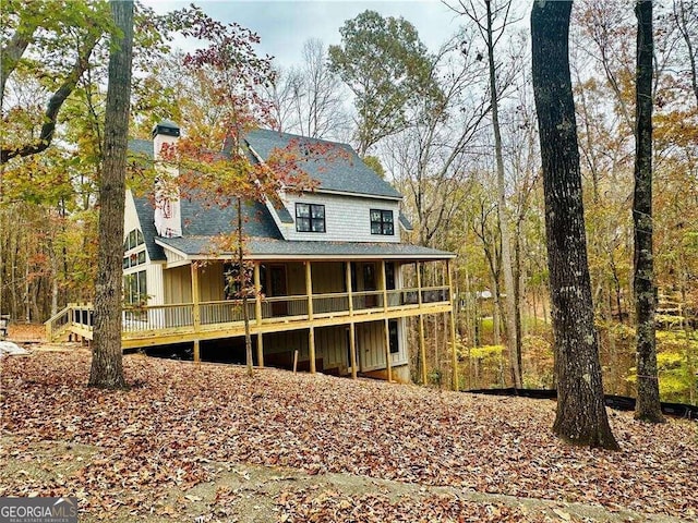 back of house featuring a deck