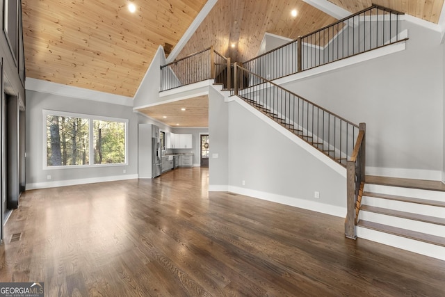 kitchen with wooden ceiling, sink, hardwood / wood-style flooring, light stone counters, and stainless steel appliances