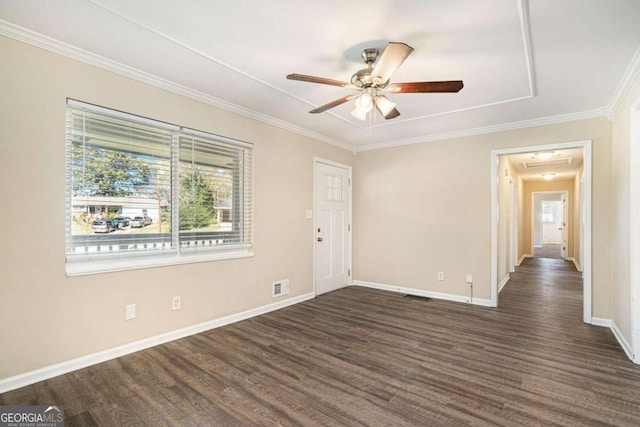 unfurnished room with ceiling fan, ornamental molding, and dark wood-type flooring