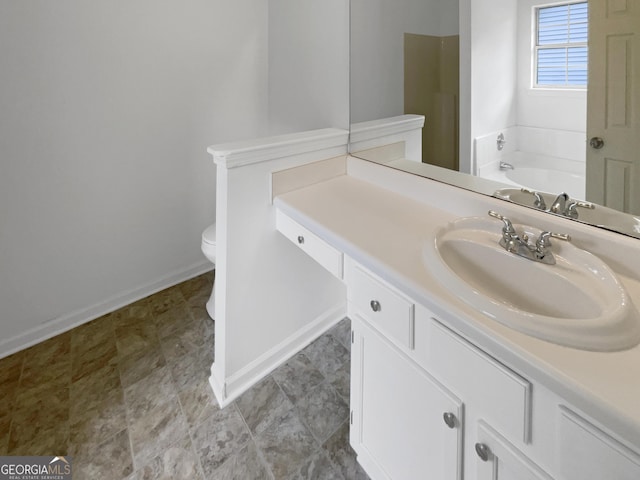 bathroom featuring vanity, toilet, and a tub