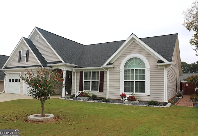 view of front of property with a front lawn and a garage