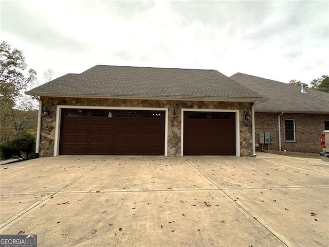 25 Fireside Ct NW, Cartersville, GA 30120 - view of front of house featuring driveway, an attached garage, stone siding, and roof with shingles