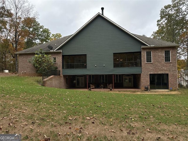 back of house with a patio area and a yard