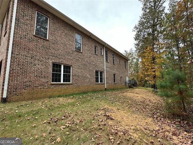 view of side of property with a yard