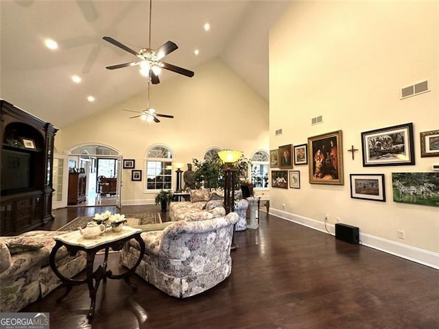 living room featuring dark hardwood / wood-style floors, ceiling fan, and high vaulted ceiling