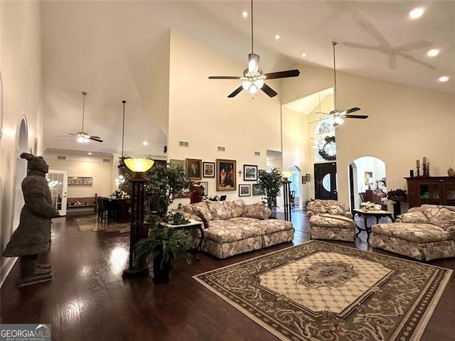 living room with dark wood-type flooring and high vaulted ceiling