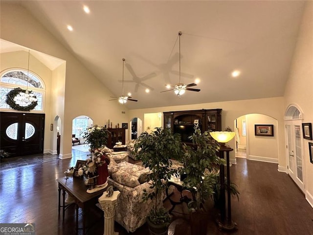 living room with ceiling fan, dark hardwood / wood-style flooring, high vaulted ceiling, and french doors