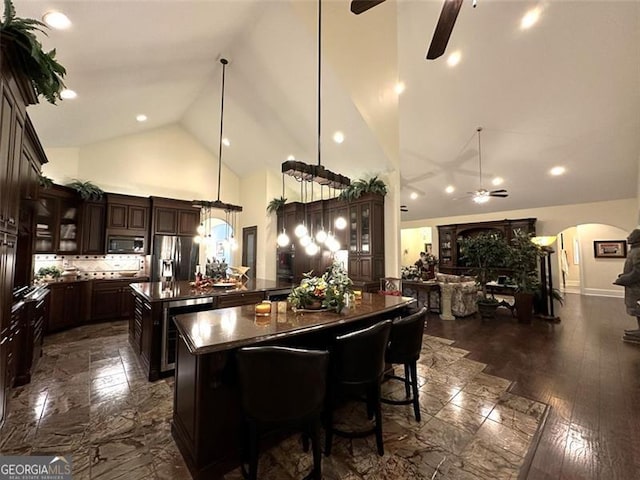 25 Fireside Ct NW, Cartersville, GA 30120 - kitchen with a ceiling fan, stainless steel appliances, a large island with sink, arched walkways, and high vaulted ceiling
